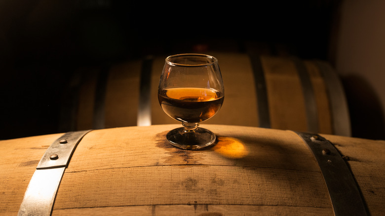 glass of whiskey on barrel