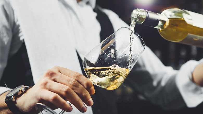 sommelier pouring Pinot Grigio wine