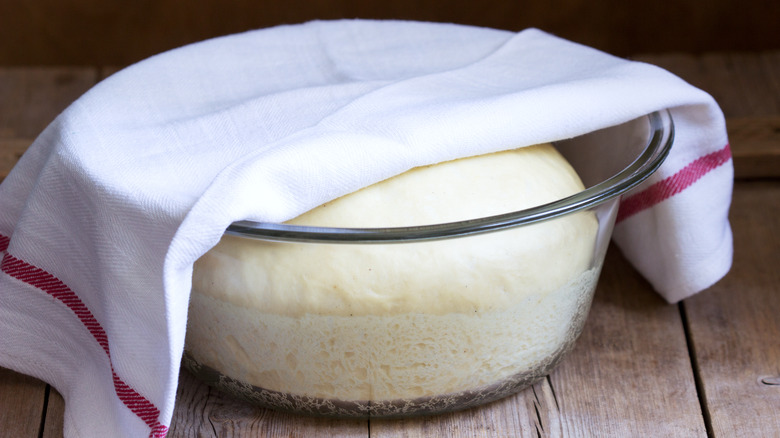 Bread dough in glass bowl