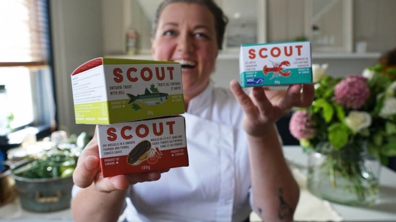 Person smiling holding Scout products