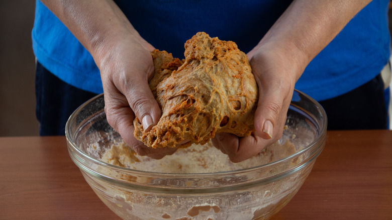 Person preparing seitan in bowl