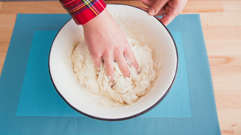 Hands kneading seitan