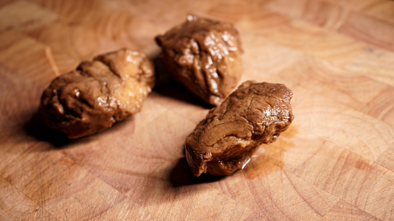 Pieces of seitan on wood