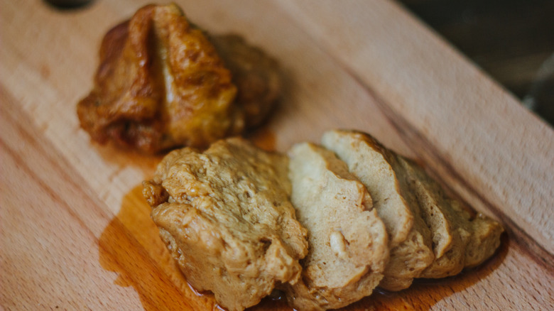 Seitan sitting on wooden board