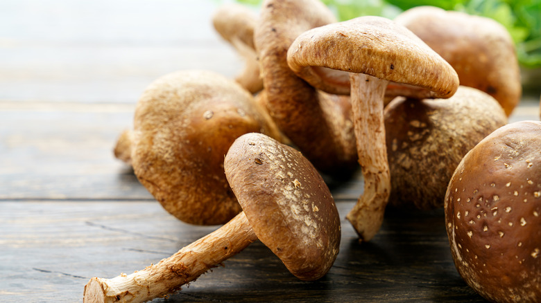 Whole raw shiitakes on wood