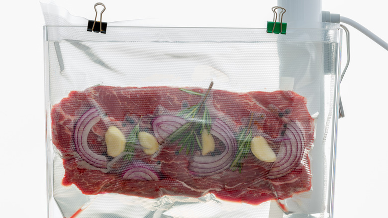 Steak and herbs in bag