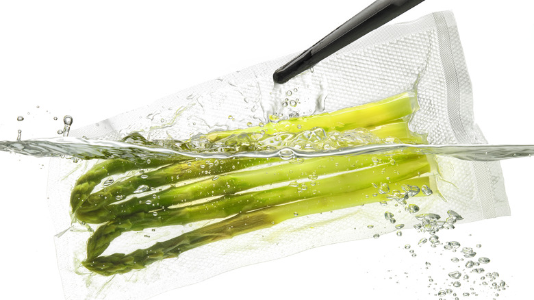 Vacuum sealed asparagus in water bath