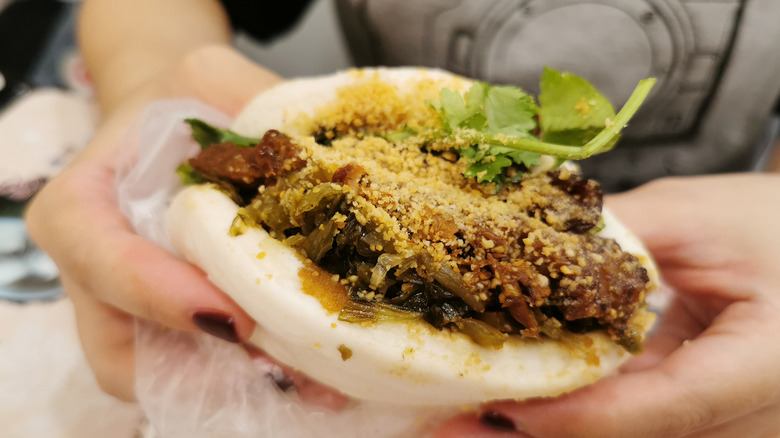 Person holding gua bao