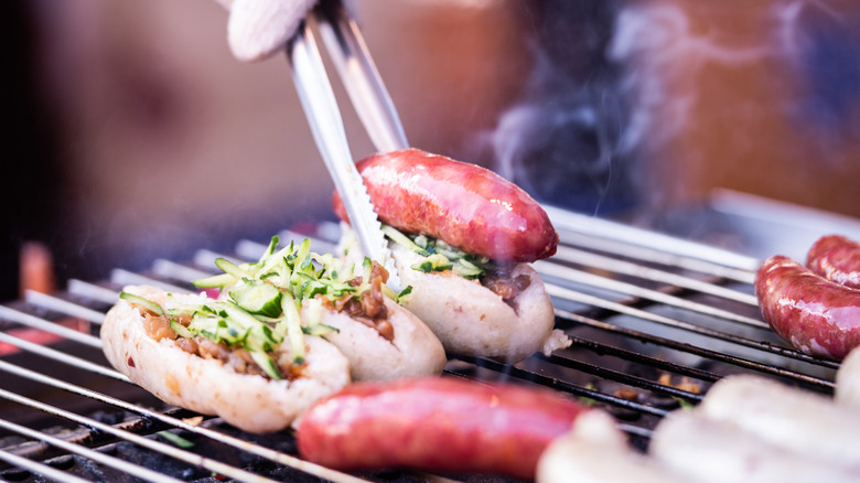 Person cooking sausage