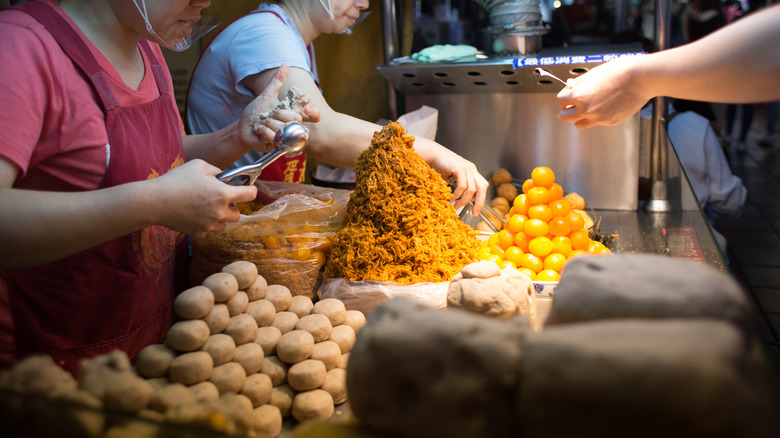 Hawkers making fried taro balls
