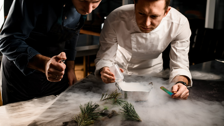 chefs observing smoking tin