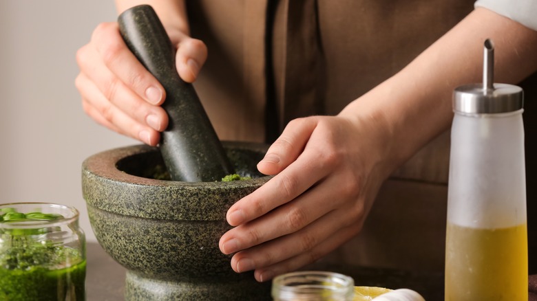 Person grinding in mortar and pestle