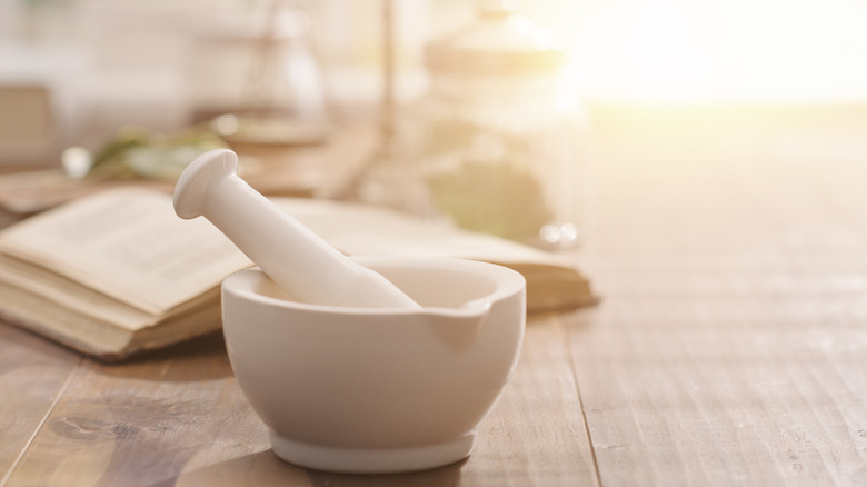 White mortar and pestle on table