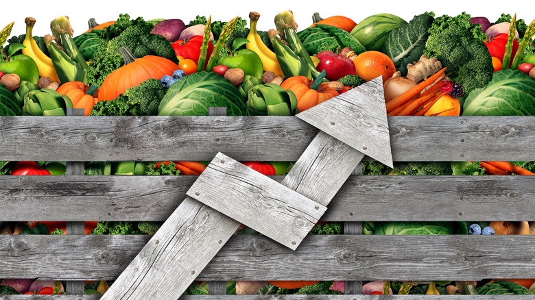 Fruits and vegetables with wooden arrow