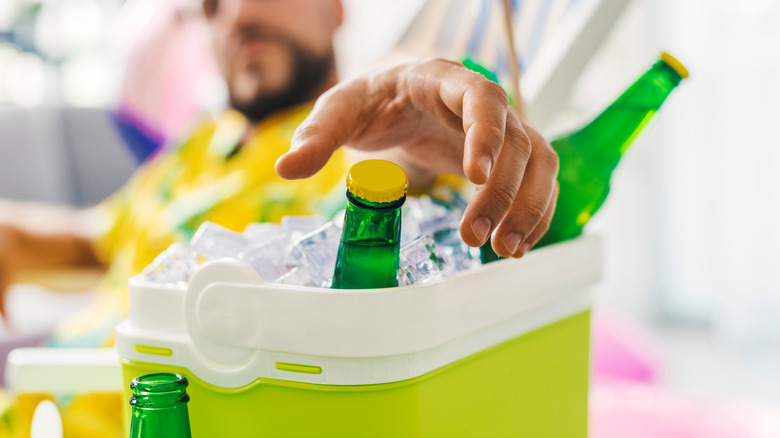 Man grabbing drink from cooler