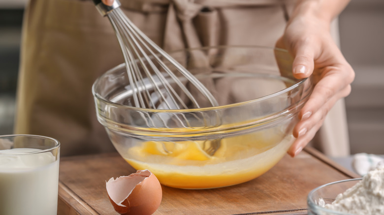 Person whisking eggs in bowl