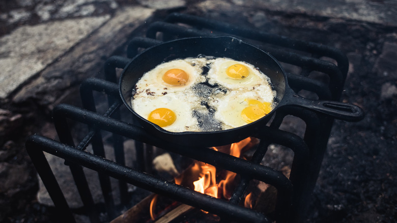 Eggs cooking in cast iron pan