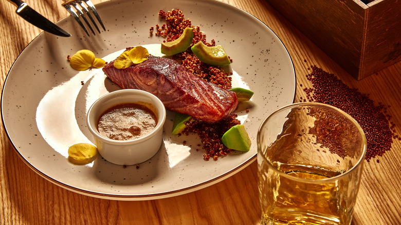 Salmon and quinoa with glass of whiskey