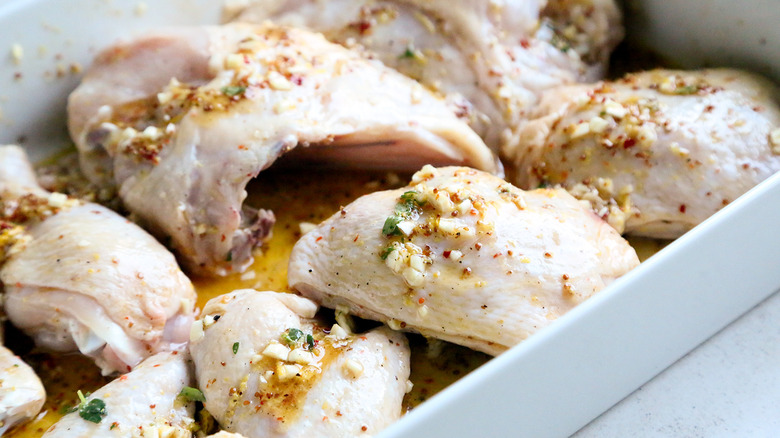 uncooked marinated chicken in pan