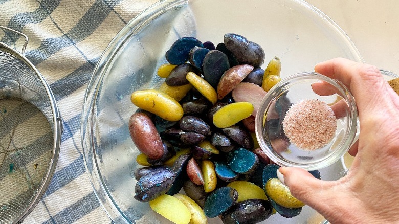 potatoes in glass bowl with seasoning