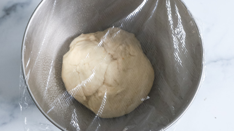 dough rising in covered bowl