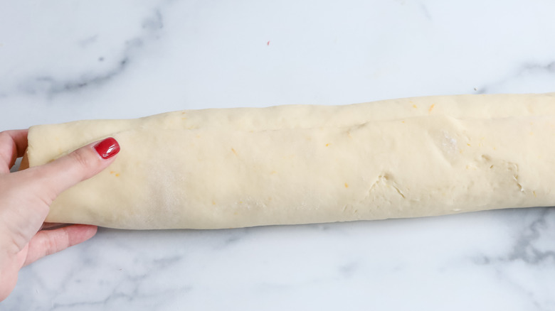 log of rolled cinnamon dough