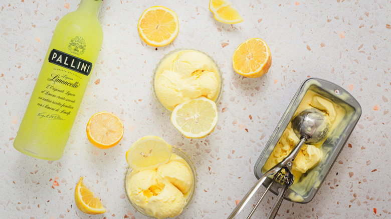 Two servings of lemon gelato, limoncello and lemons