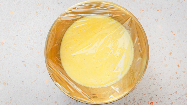 Bowl with lemon gelato wrapped in plastic