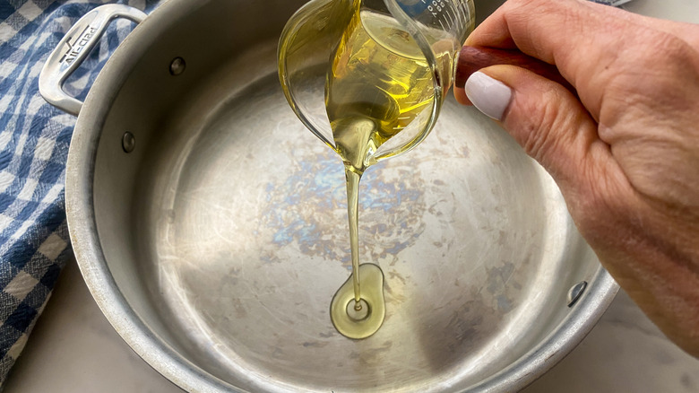 adding oil to a pan