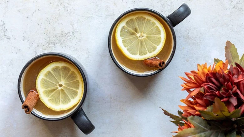 Mugs of Hot Toddy with lemon slice