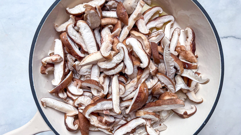assorted mushrooms cooking in skillet