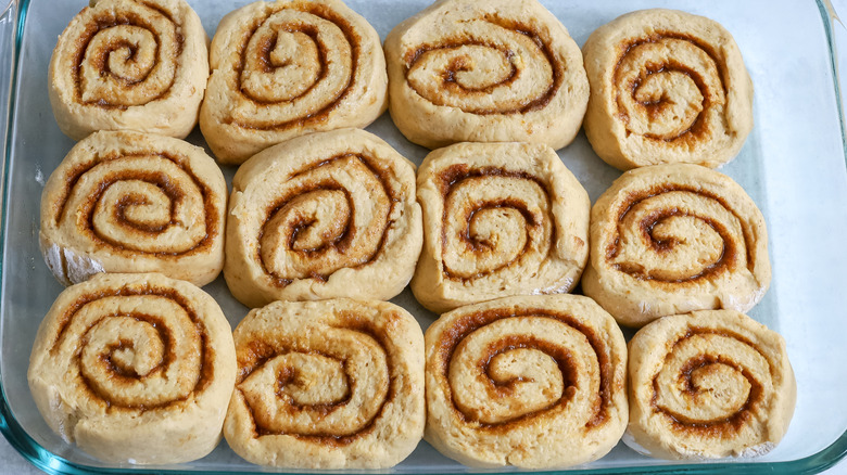 risen cinnamon rolls in dish