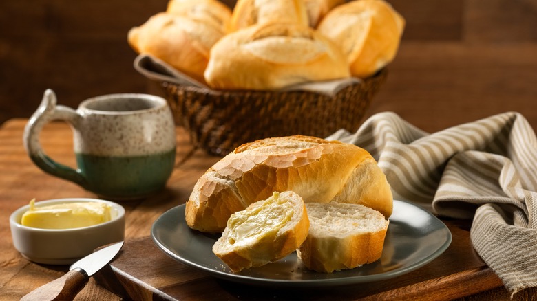 bread basket on table with butter and coffee