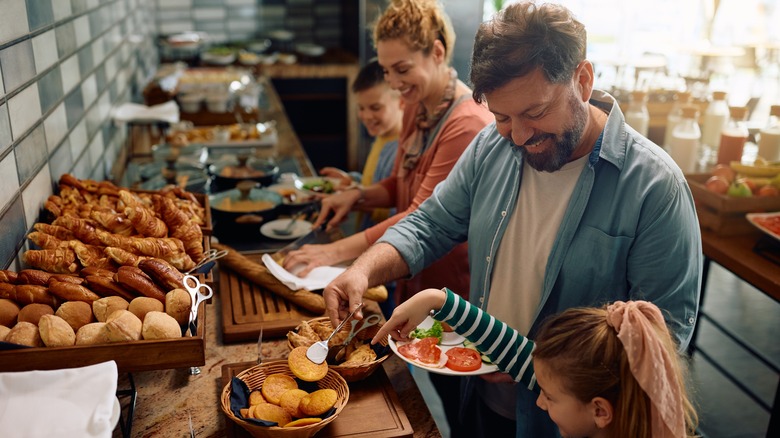 happy family enjoying getting buffet food