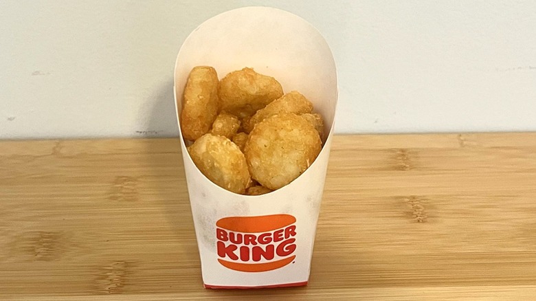 Burger King hash browns sit on a table.