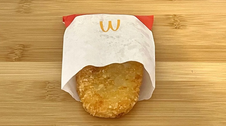 McDonald's hash browns sit on a table.