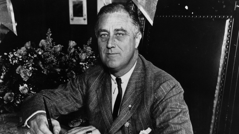 Franklin Delano Roosevelt signs a document