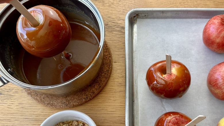 Dipping apples in caramel