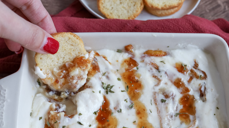 dipping crunchy bread into ricotta dip