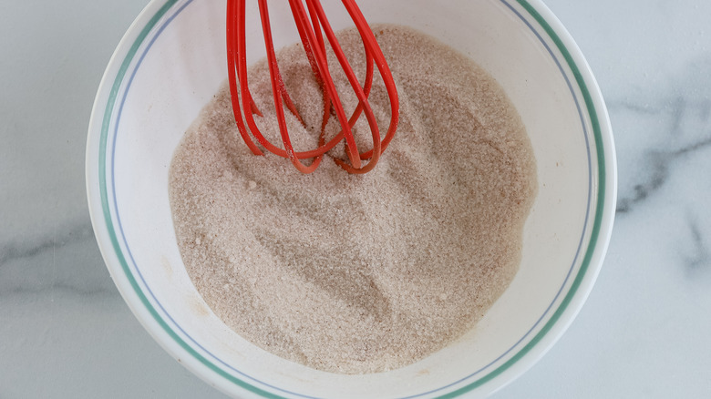 whisking sugar and spices in bowl