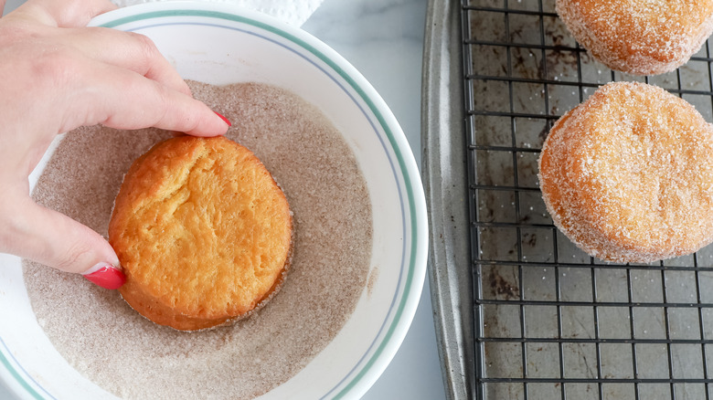 dipping donuts in spiced sugar