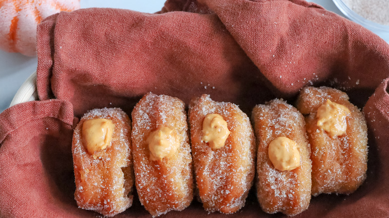 pumpkin stuffed donuts in cloth wrapped bowl