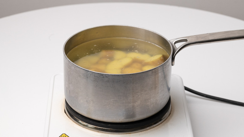 boiling potatoes in a saucepan