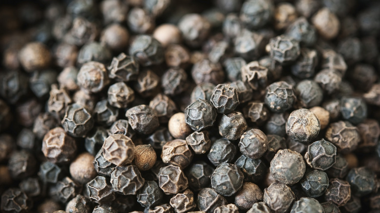 Close-up of many black peppercorns 