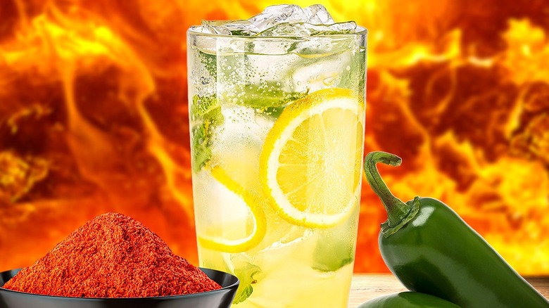 Glass of lemonade next to chili powder and jalapeño