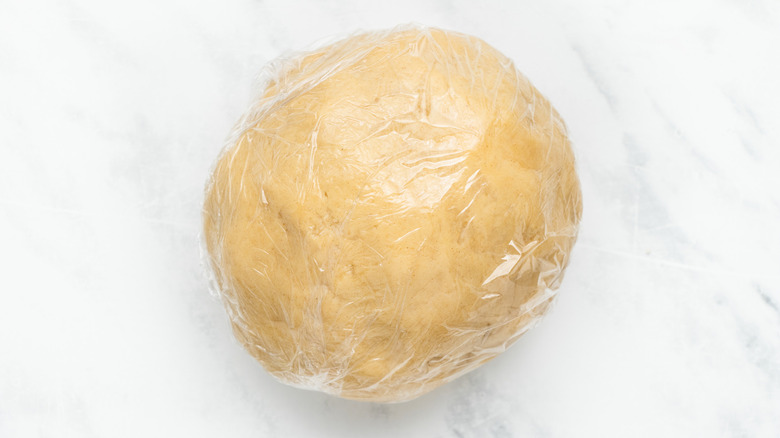 dough ball in plastic wrap