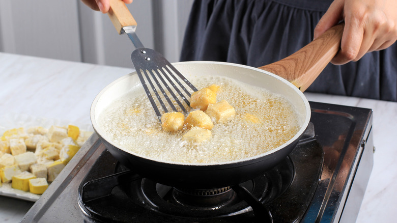 tofu frying on gas stove