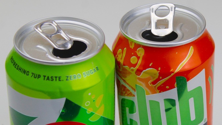 Close-up of two open cans of soda pop