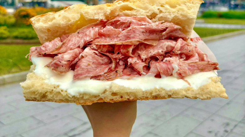 All'Antico Vinaio salami sandwich held up outside