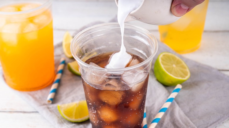 Pouring cream into a dirty soda